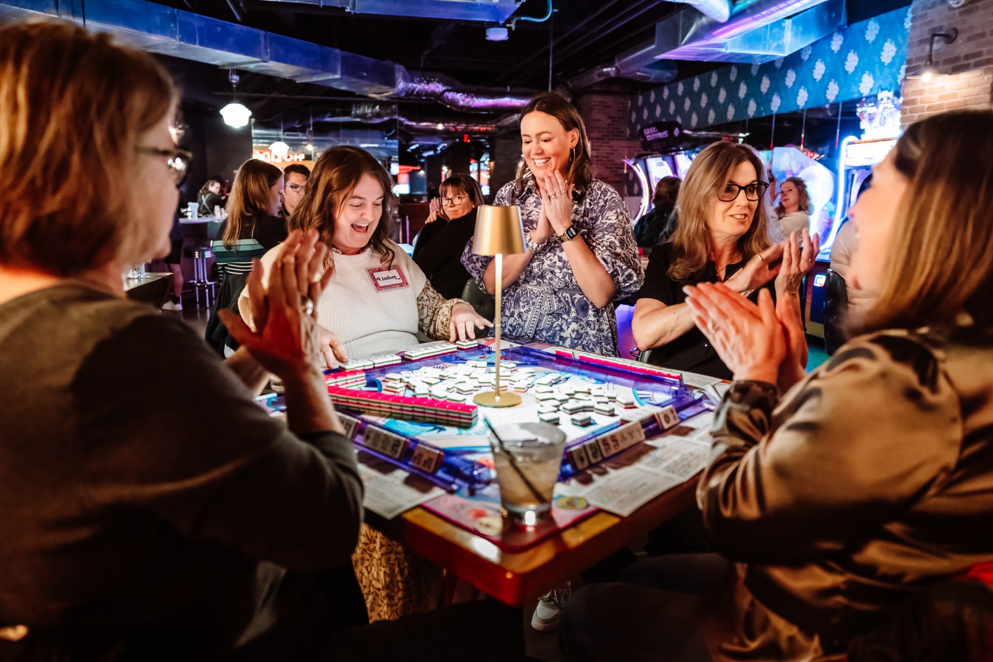 Players around a mahjong table at a Bird Bam Beth night in Portland